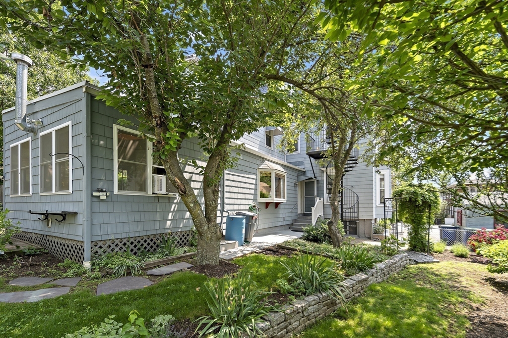 38 Spring Street Somerville, MA 02143 - Photo 5 of 37 a front view of a house with a garden