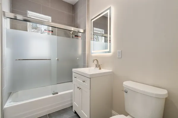 a bathroom with a sink toilet and shower