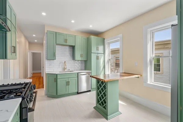 a kitchen with a sink stove and cabinets