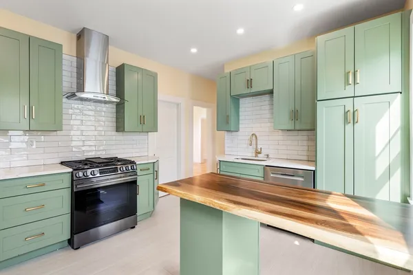 a kitchen with a sink stove and refrigerator