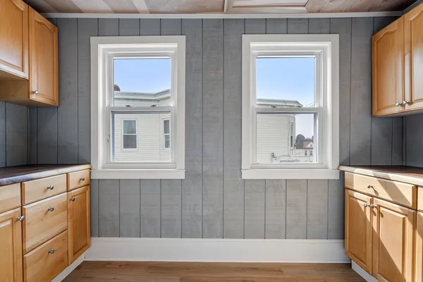 a kitchen with stainless steel appliances cabinets and a window