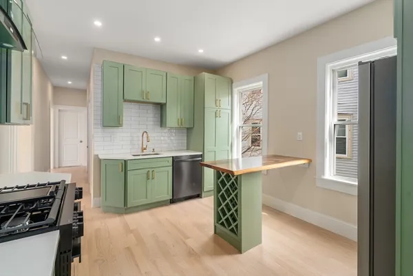 a kitchen with a sink stove and cabinets
