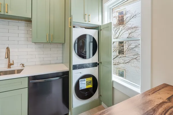 a utility room with sink dryer and washer