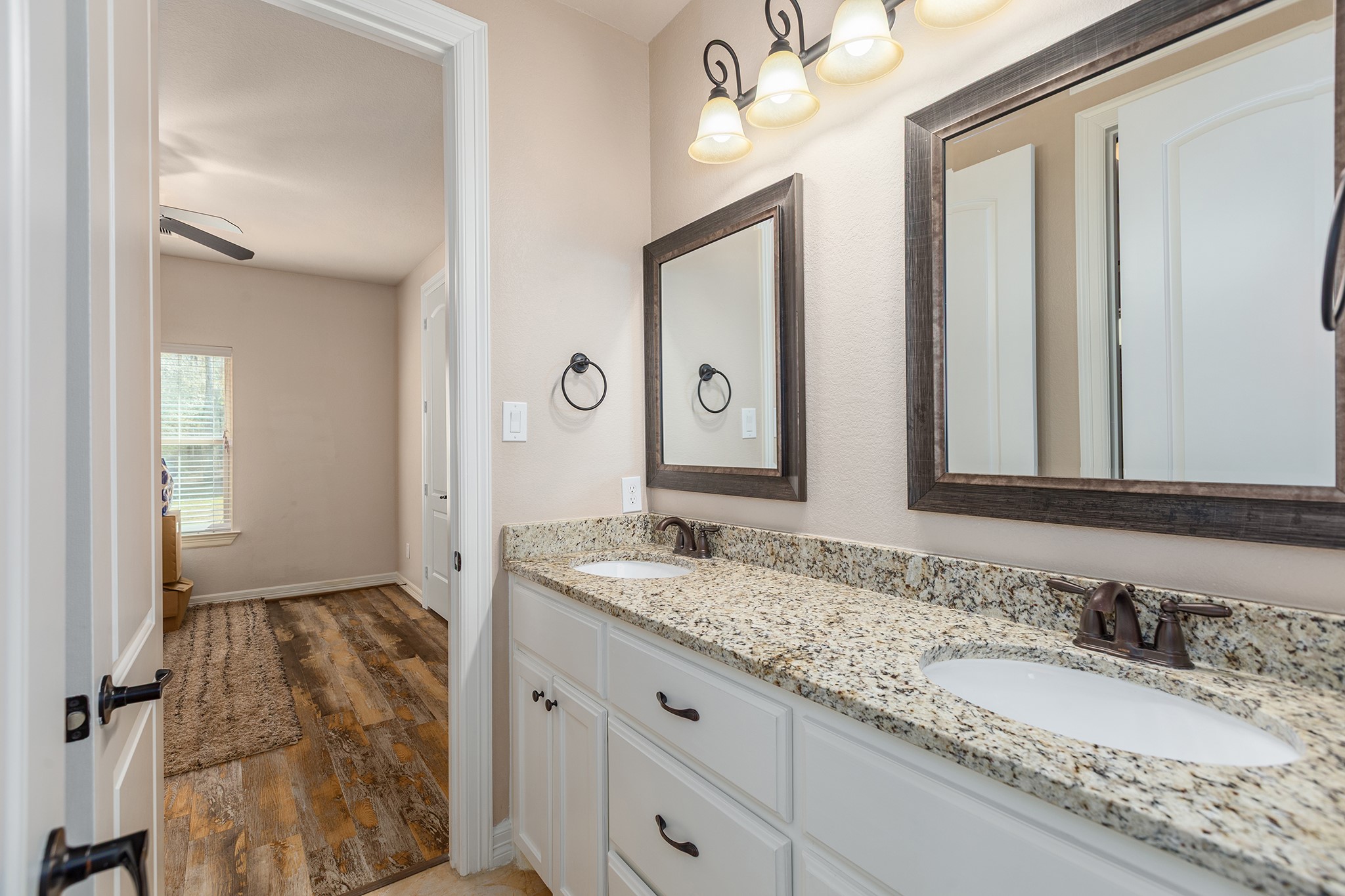 27688 Rio Blanco Drive Splendora, TX 77372 - Photo 28 of 50 a bathroom with a granite countertop sink and a mirror