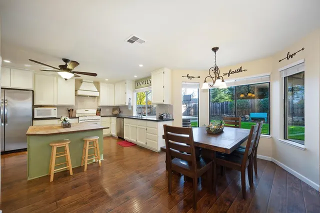 a living room with furniture a dining table and a fireplace