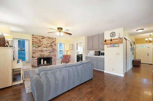 a living room with furniture and kitchen view