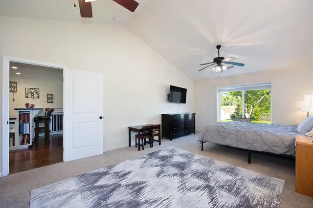 a bedroom with a bed and a large mirror