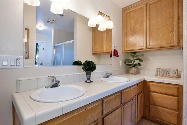 a large bed sitting in a bedroom next to a window