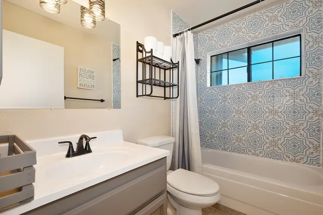 a view of deck with furniture and trees in the background