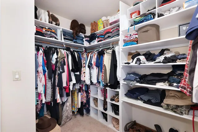 an aerial view of residential houses with city and green space