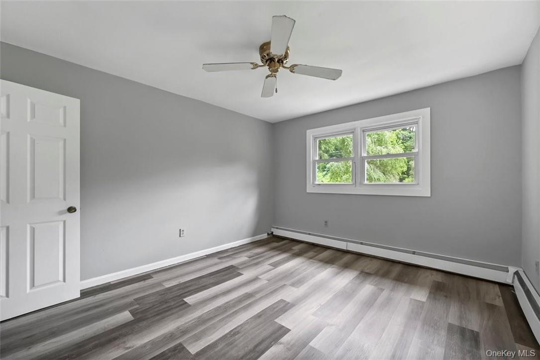 35 Peddler Hill Road Monroe, NY 10950 - Photo 12 of 23 Empty room with ceiling fan, wood-type flooring, and baseboard heating