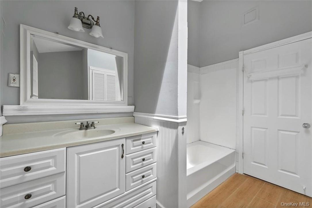 35 Peddler Hill Road Monroe, NY 10950 - Photo 14 of 23 Bathroom with wood-type flooring, shower / tub combination, and vanity