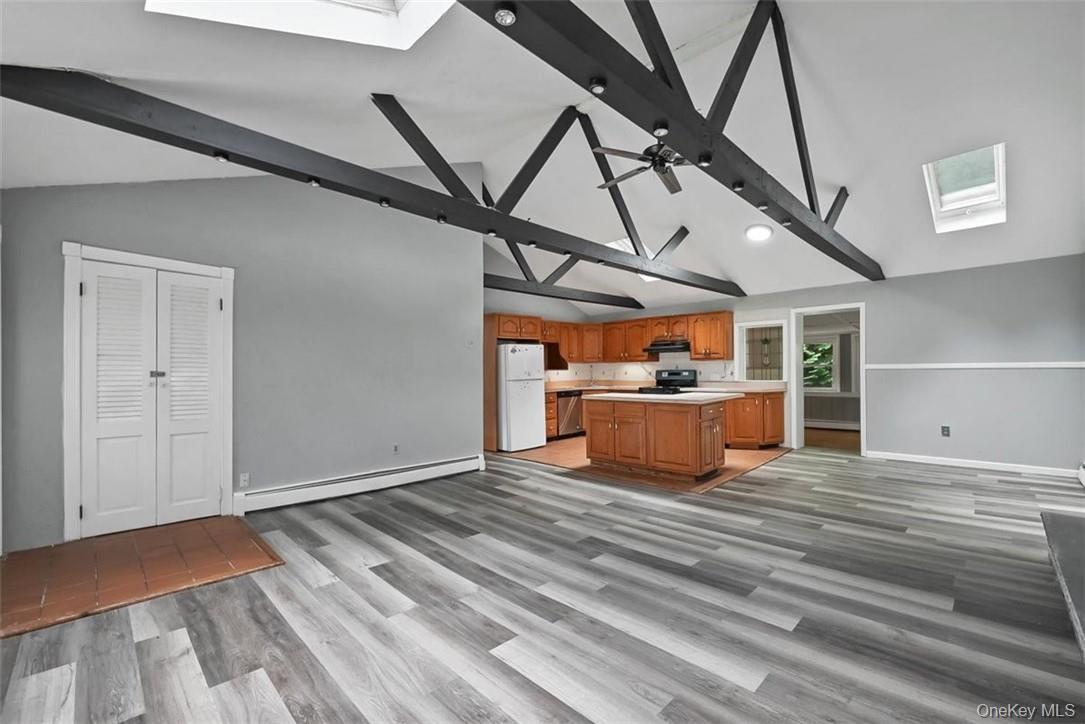 35 Peddler Hill Road Monroe, NY 10950 - Photo 5 of 23 Kitchen with beamed ceiling, light hardwood / wood-style flooring, white refrigerator, a skylight, and baseboard heating