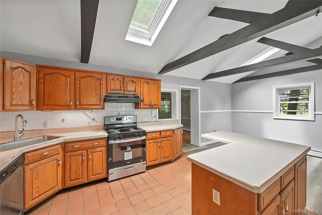 35 Peddler Hill Road Monroe, NY 10950 - Photo 8 of 23 Kitchen featuring appliances with stainless steel finishes, tasteful backsplash, sink, light tile patterned floors, and lofted ceiling with skylight