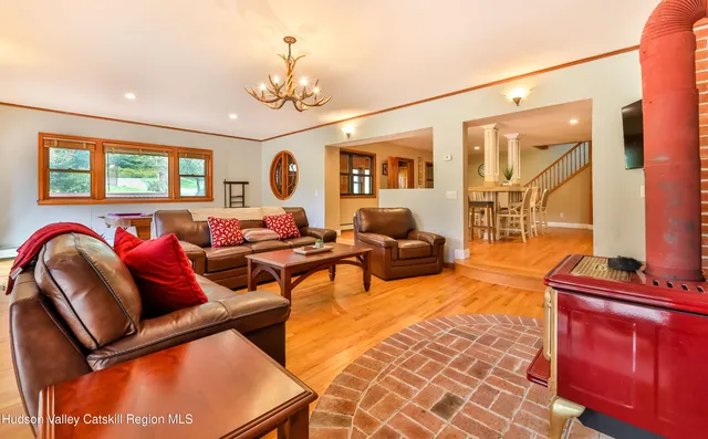 a living room with furniture and a chandelier
