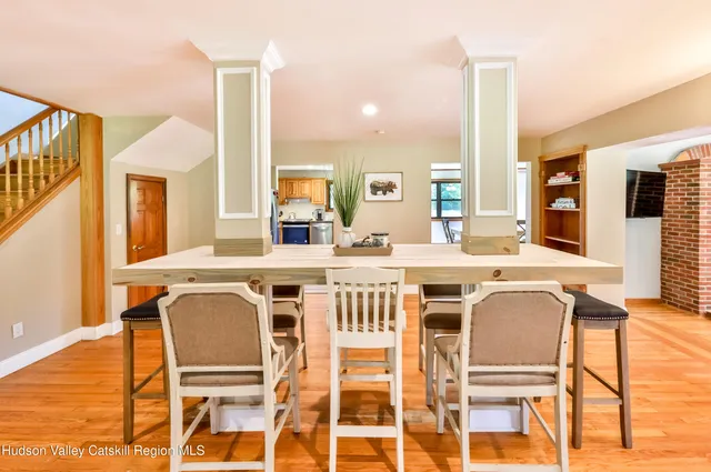 a dining room with furniture and wooden floor