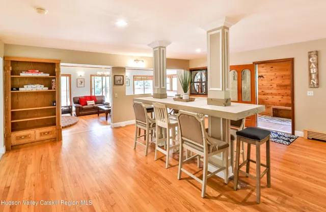 a view of a dining room with furniture wooden floor and chandelier