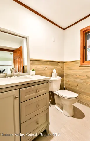 a bathroom with a toilet a sink and a mirror