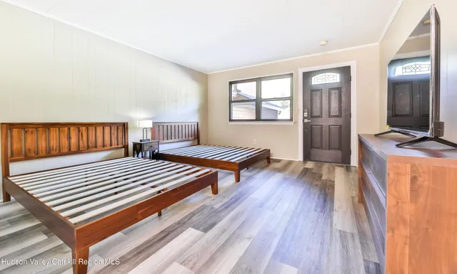 a bedroom with furniture and wooden floor