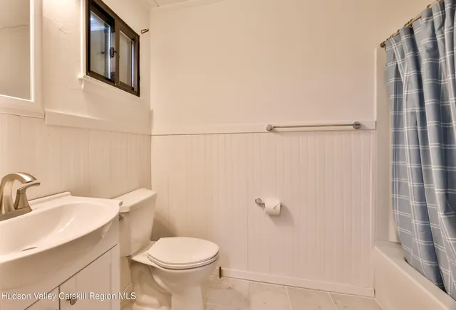 a white toilet sitting next to a bathroom sink