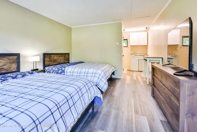 a bed room with a bed and a television