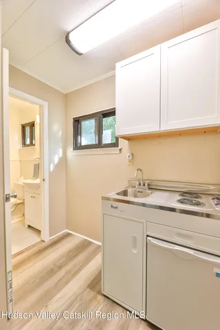 a room with a sink and cabinets