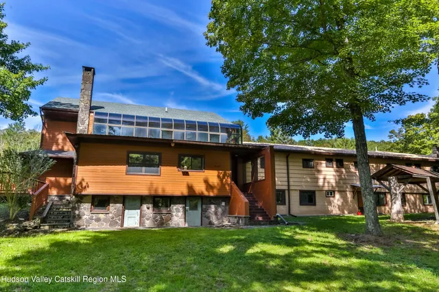 a front view of house with yard and outdoor seating
