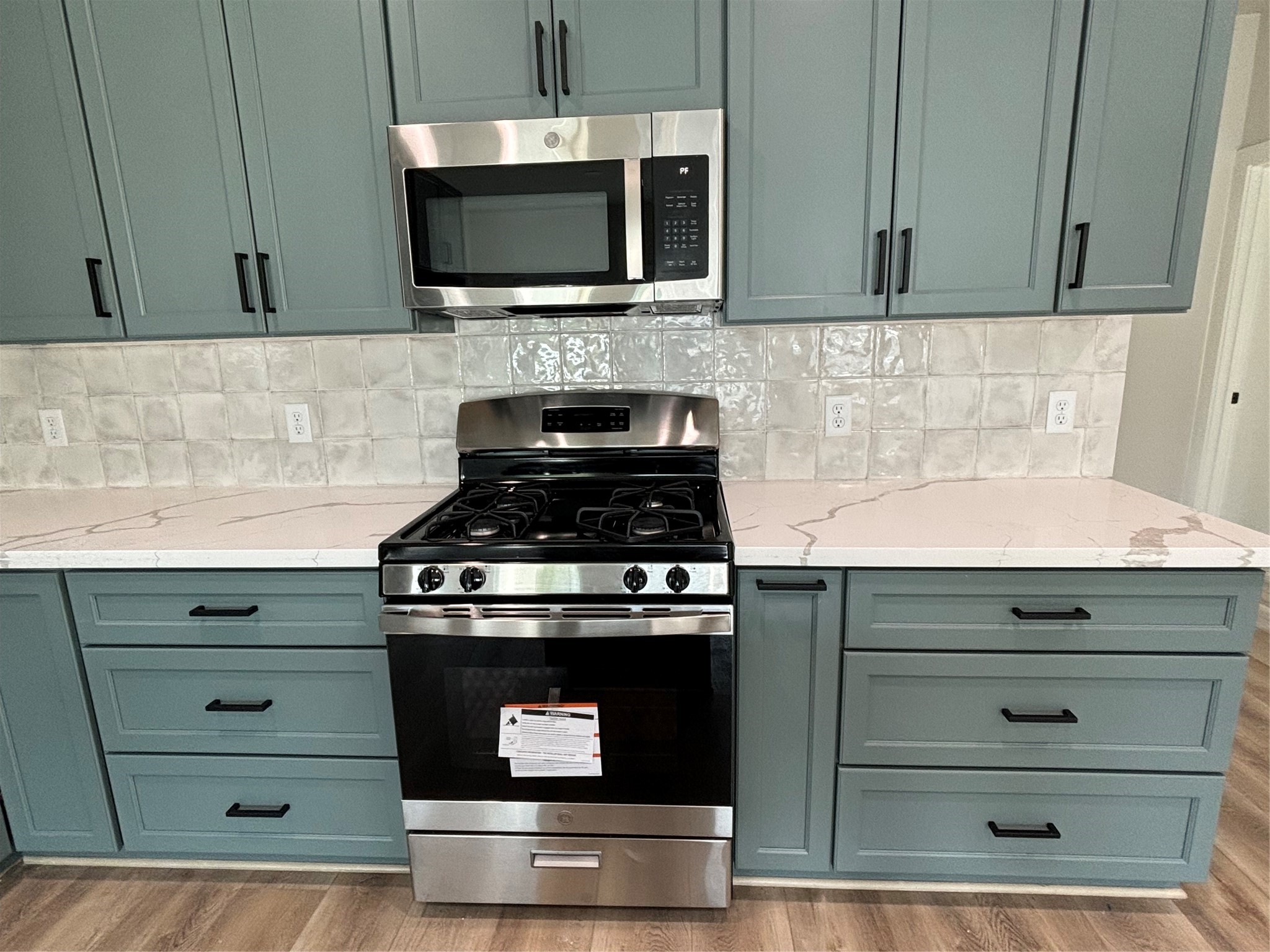 3604 Dennis Street Houston, TX 77004 - Photo 5 of 20 a kitchen with a stove and a microwave