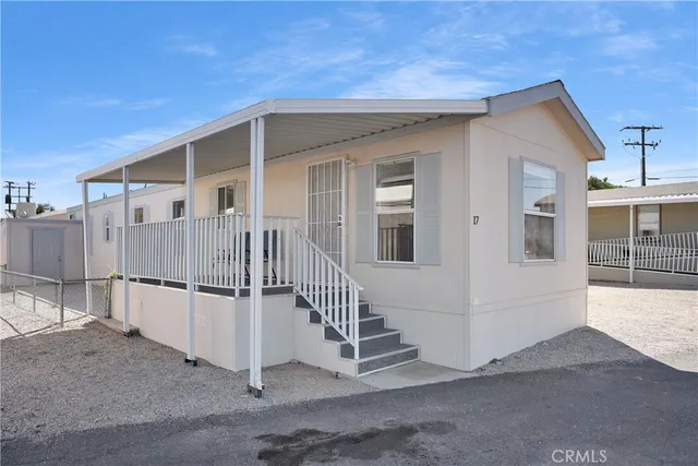 a view of a house with wooden fence