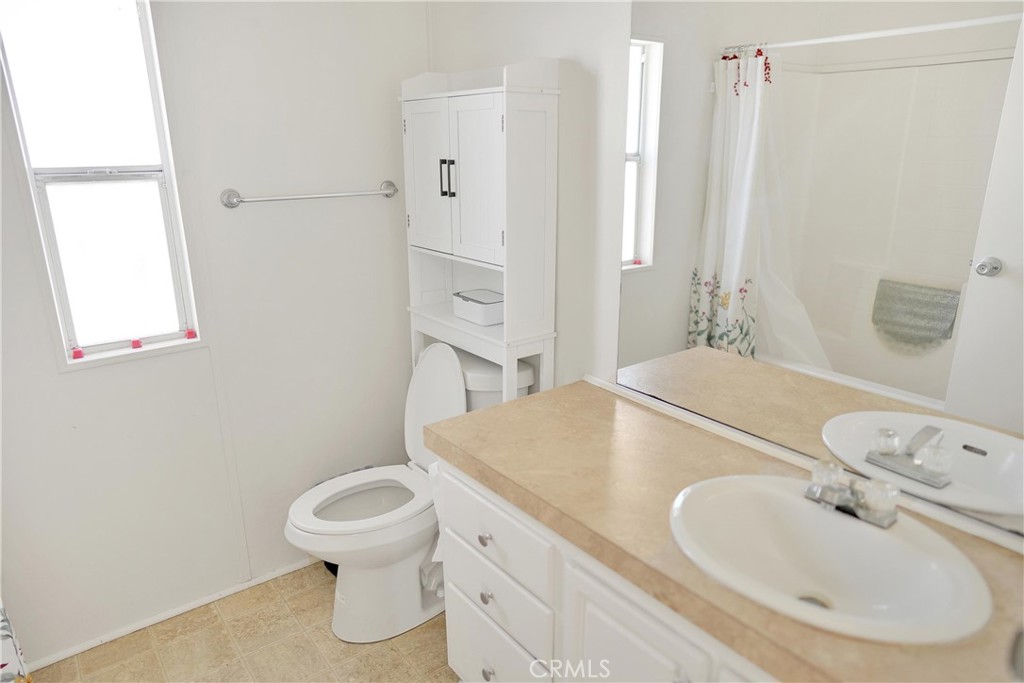 22601 Bear Valley Road, Unit 17 Apple Valley, CA 92308 - Photo 12 of 36 a bathroom with a sink toilet and shower