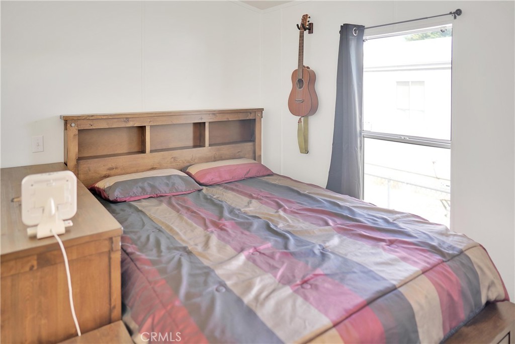 22601 Bear Valley Road, Unit 17 Apple Valley, CA 92308 - Photo 15 of 36 a bedroom with a bed and window