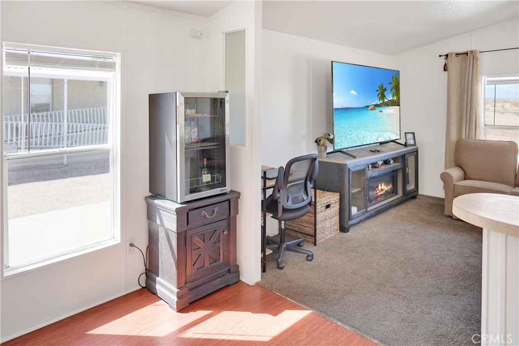 22601 Bear Valley Road, Unit 17 Apple Valley, CA 92308 - Photo 18 of 36 a living room with furniture a flat screen tv and a window