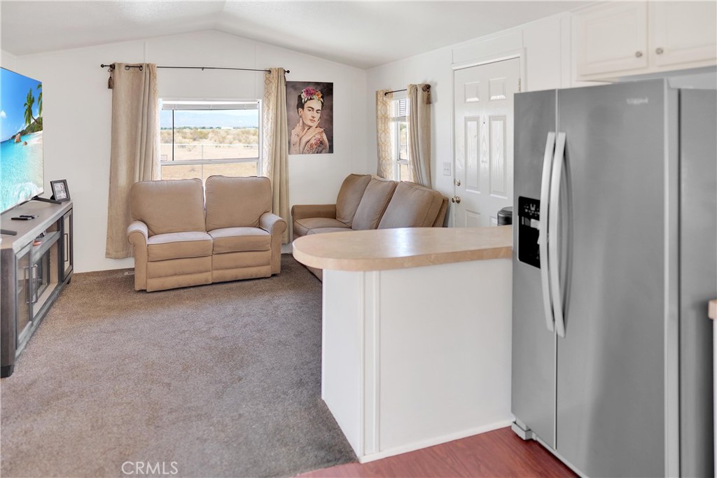 22601 Bear Valley Road, Unit 17 Apple Valley, CA 92308 - Photo 19 of 36 a living room with furniture and a refrigerator