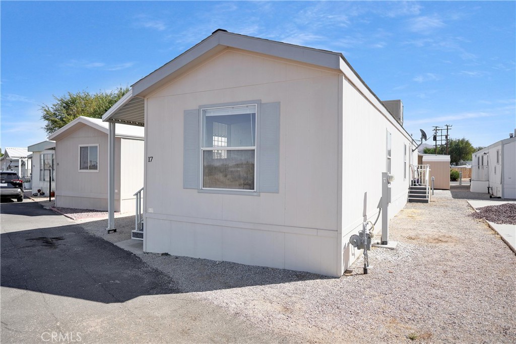 22601 Bear Valley Road, Unit 17 Apple Valley, CA 92308 - Photo 4 of 36 a view of a house with a backyard