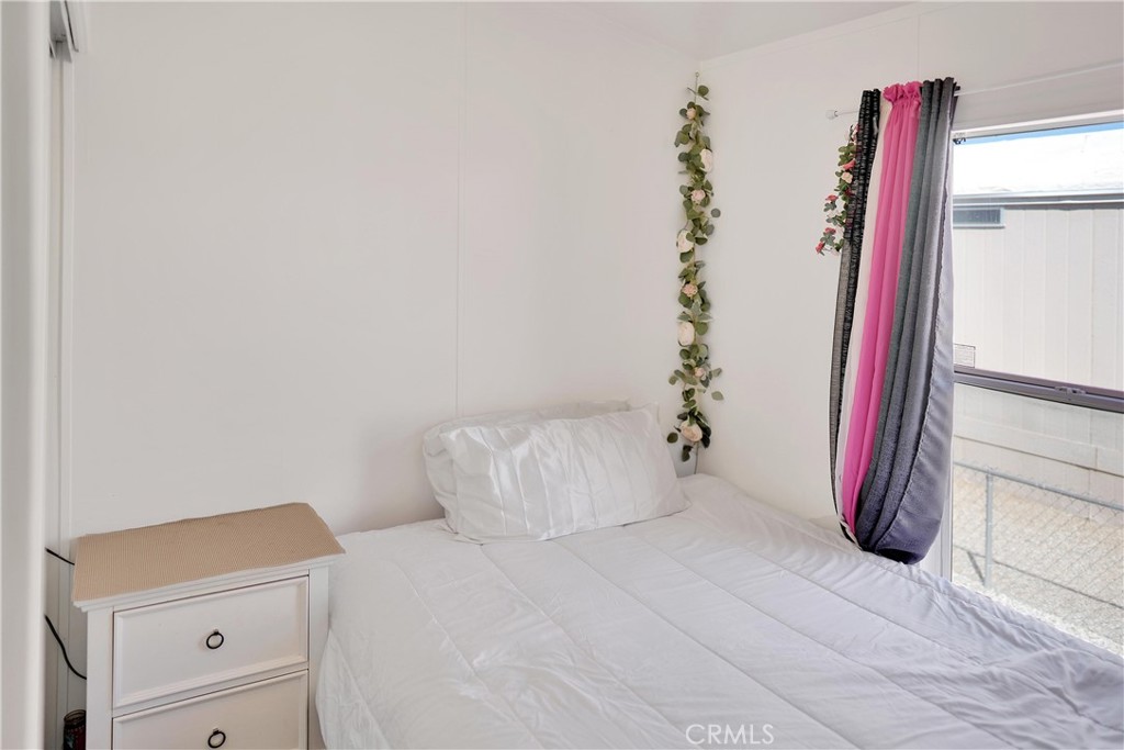 22601 Bear Valley Road, Unit 17 Apple Valley, CA 92308 - Photo 10 of 36 a bedroom with a bed and a window