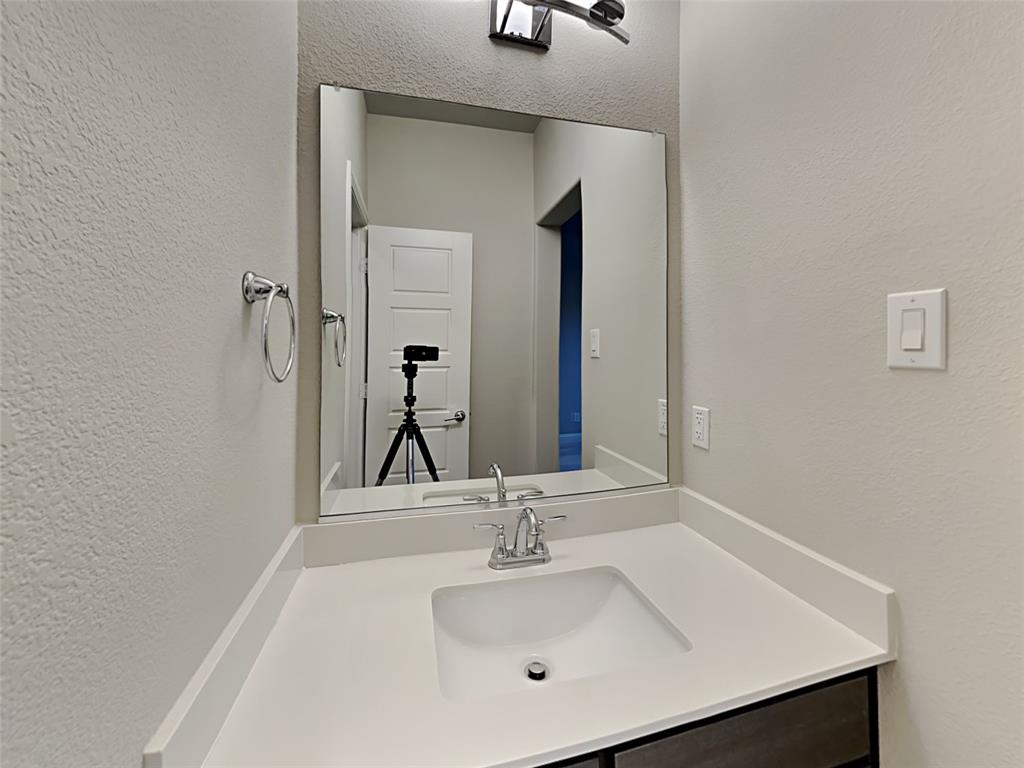 8262 Ottowa Ridge Frisco, TX 75034 - Photo 19 of 24 a bathroom with a sink and a mirror