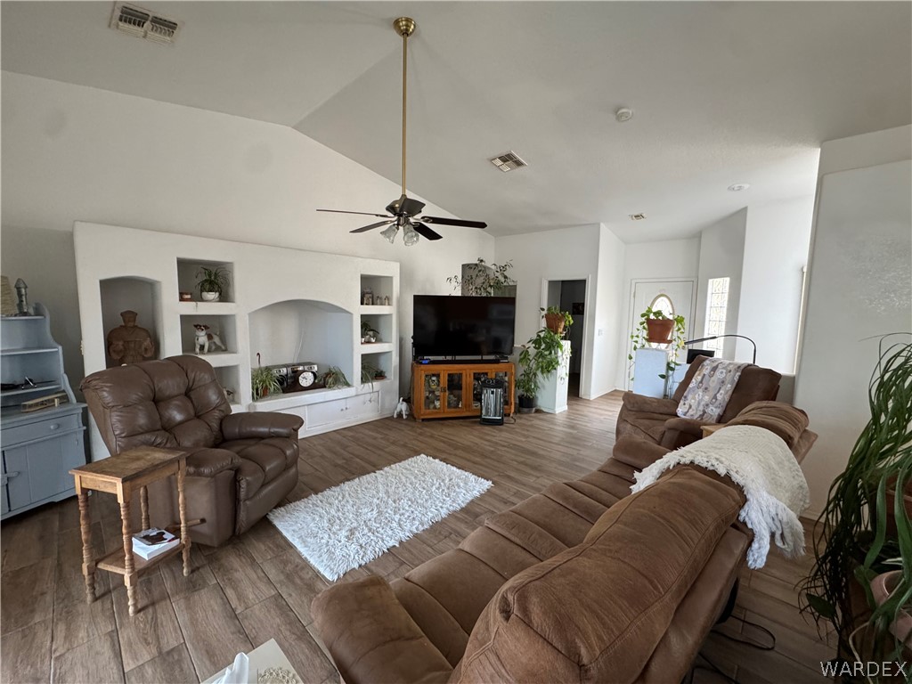 4029 Roma Road Kingman, AZ 86401 - Photo 11 of 90 The living area features vaulted ceilings, tile flooring, and a built-in media center with shelving