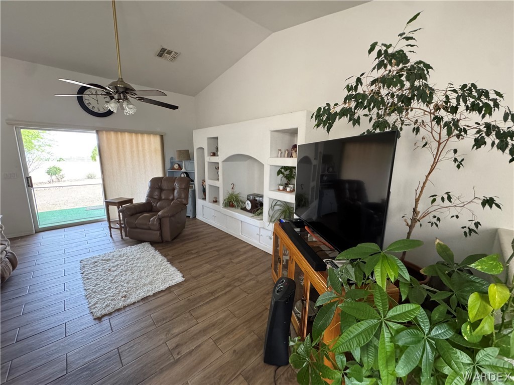 4029 Roma Road Kingman, AZ 86401 - Photo 14 of 90 This living area features vaulted ceilings, tile flooring, and a ceiling fan