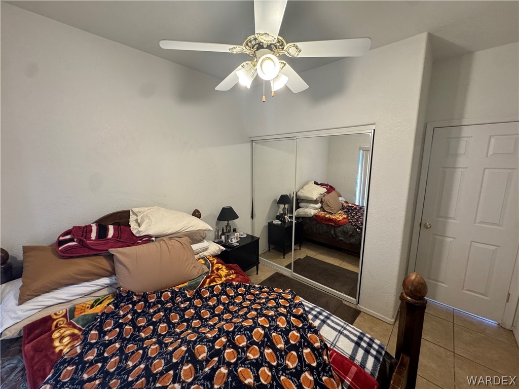 4029 Roma Road Kingman, AZ 86401 - Photo 29 of 90 The property features a room with a ceiling fan, mirrored closet doors, and a paneled door