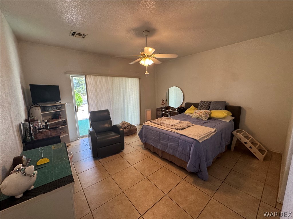 4029 Roma Road Kingman, AZ 86401 - Photo 38 of 90 This room features vaulted ceilings, tile flooring, and a ceiling fan