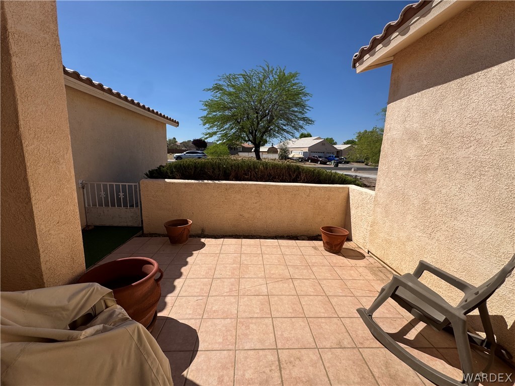 4029 Roma Road Kingman, AZ 86401 - Photo 45 of 90 The property features an outdoor patio with tiled flooring and privacy walls
