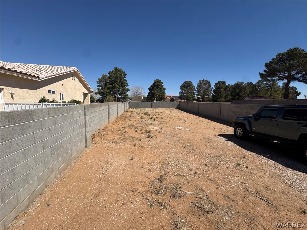4029 Roma Road Kingman, AZ 86401 - Photo 5 of 90 The property features a large, undeveloped lot with block walls defining the perimeter