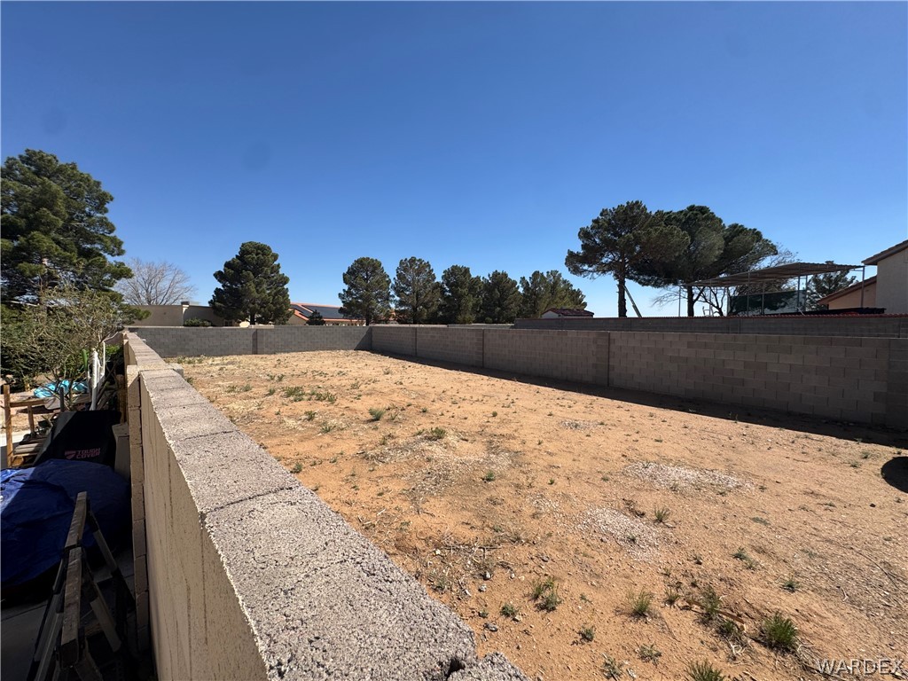 4029 Roma Road Kingman, AZ 86401 - Photo 6 of 90 The property features a spacious, undeveloped lot, enclosed by block walls on three sides