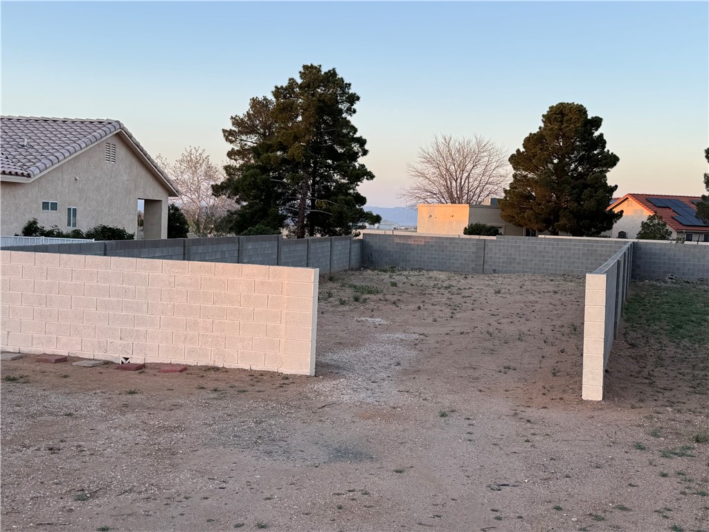 4029 Roma Road Kingman, AZ 86401 - Photo 78 of 90 The property features a level lot, enclosed by block walls, providing a clear and defined space