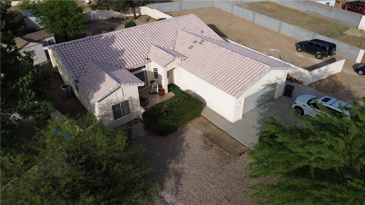 4029 Roma Road Kingman, AZ 86401 - Photo 86 of 90 This property features a stucco exterior with a tiled roof, an attached garage, and a paved driveway