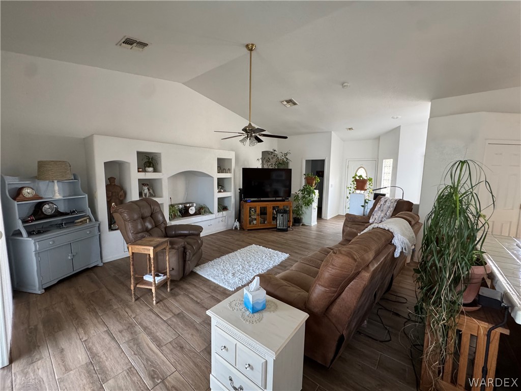 4029 Roma Road Kingman, AZ 86401 - Photo 10 of 90 Living area featuring vaulted ceilings, recessed lighting, and wood-look flooring