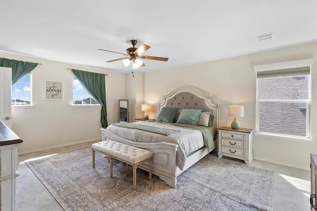 a bedroom with a bed a chandelier and a window