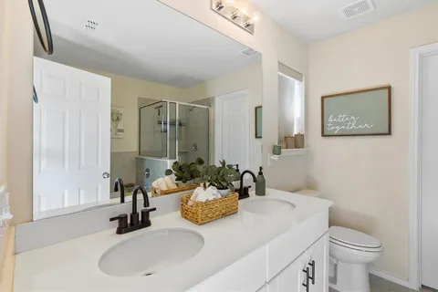 a bathroom with a sink and a mirror with toilet