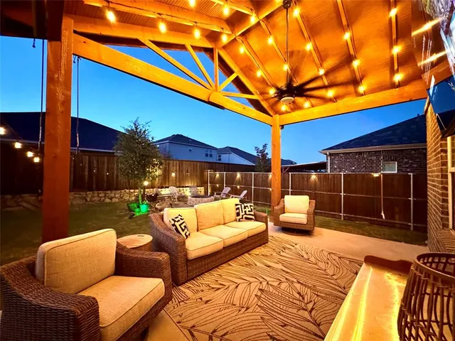 a balcony with furniture and a potted plant