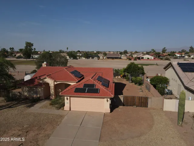 an aerial view of a house with a garden and lake view